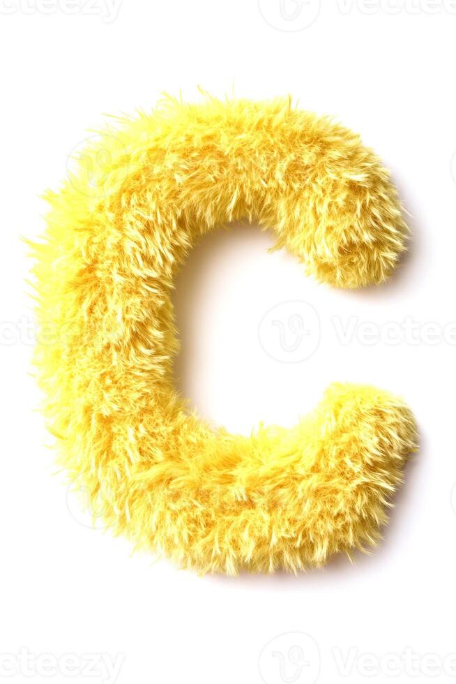 Soft and fluffy yellow letter C is displayed on a white background, showcasing its bright color and fun texture ideal for kids' decor or toys photo