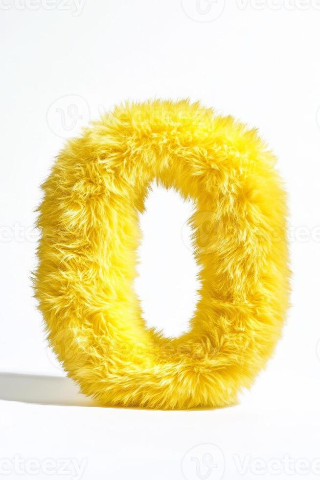 The bright yellow fluffy letter O stands out against a pure white backdrop, emphasizing its soft texture and cheerful appearance photo