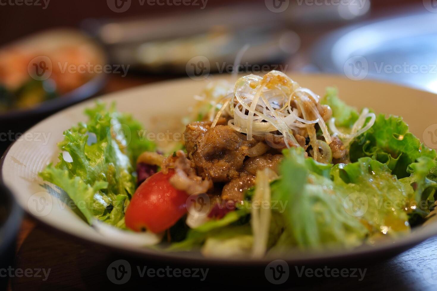 with beef salad Spicy Beef Slices Meat Salad with Carrots, Tomatoes, Cucumber, Parsley, Radish and Salad leaves Spinach, rocket, red ruby chard on old wooden table photo