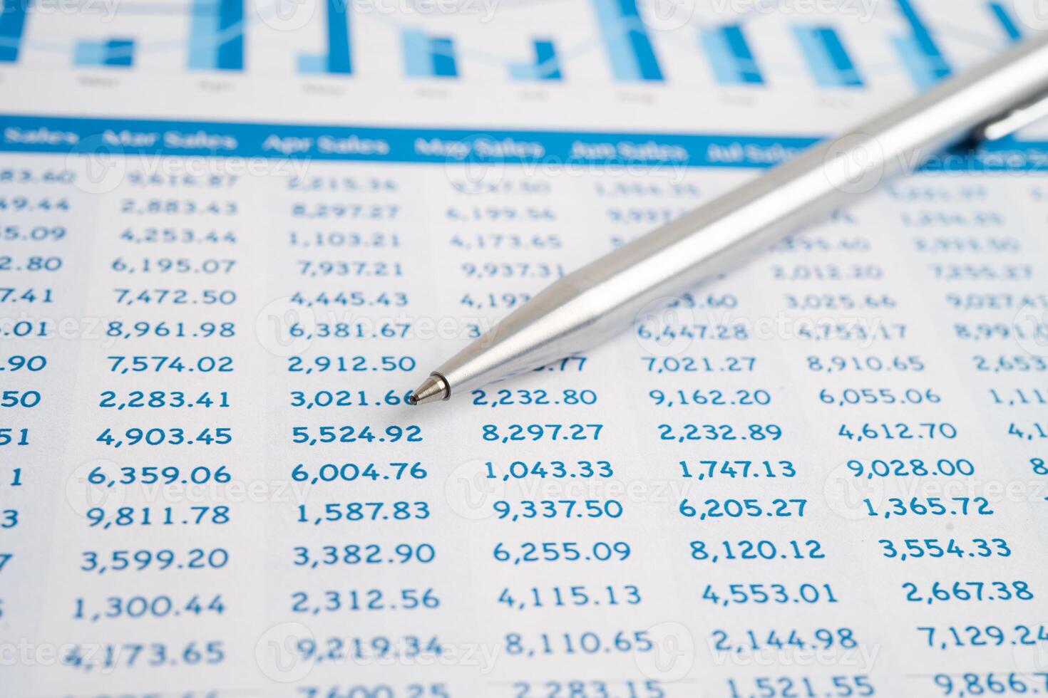 Pen on spreadsheet and graph paper. photo