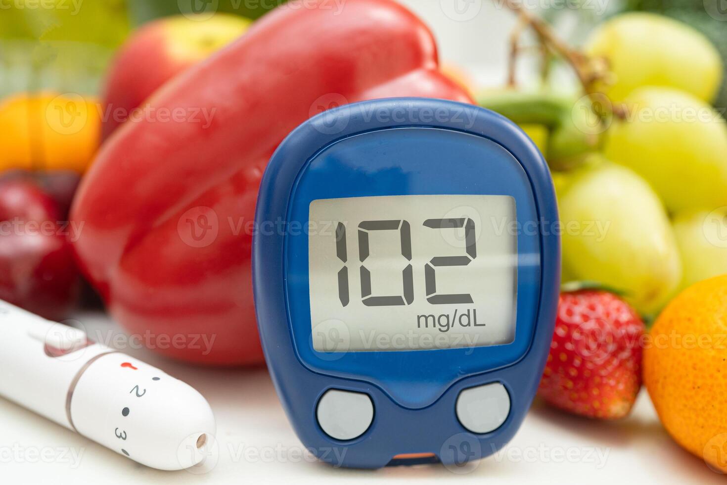 hand holding digital glucose monitor measure with vegetable and fruit healthy food. photo