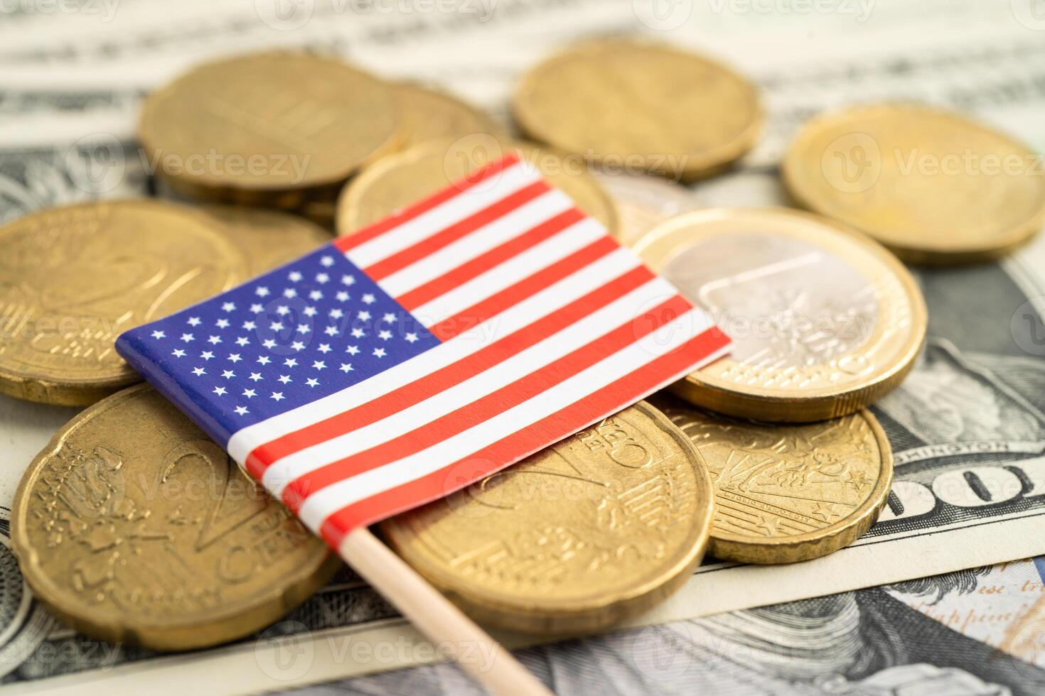 Stack of coins with US America flag and US dollar banknotes. photo