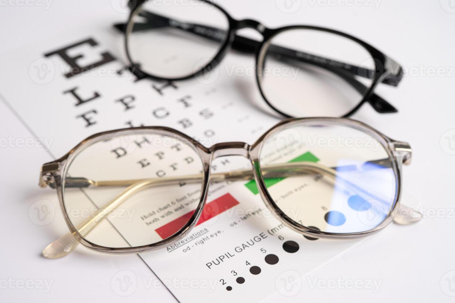 Glasses on eye testing exam chart to check eyesight photo
