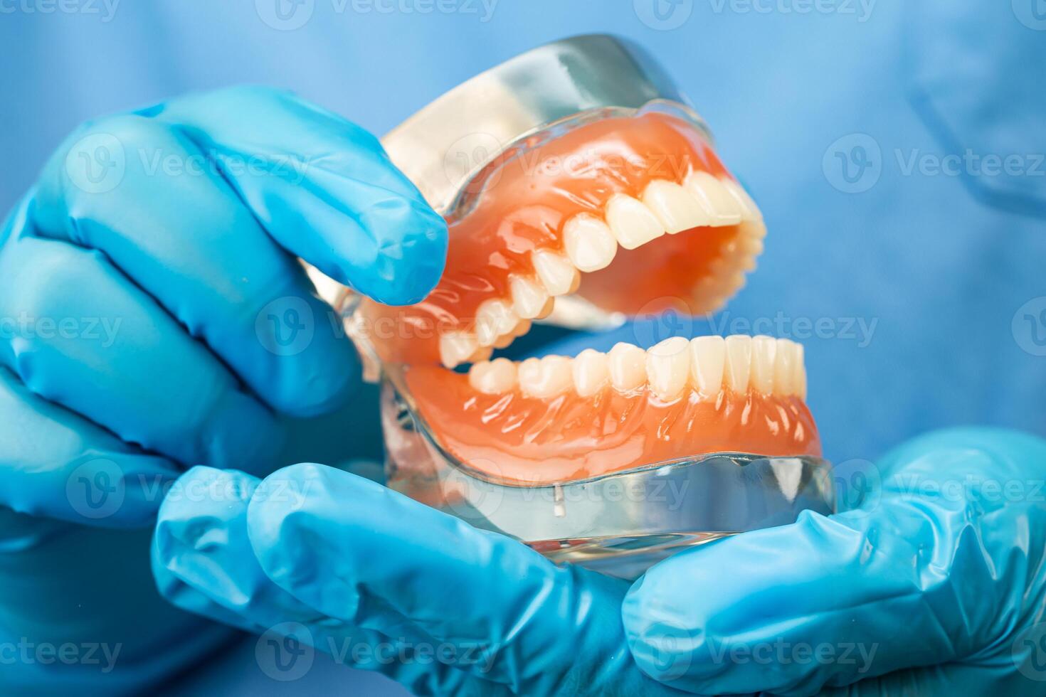 Denture dentist holding photo