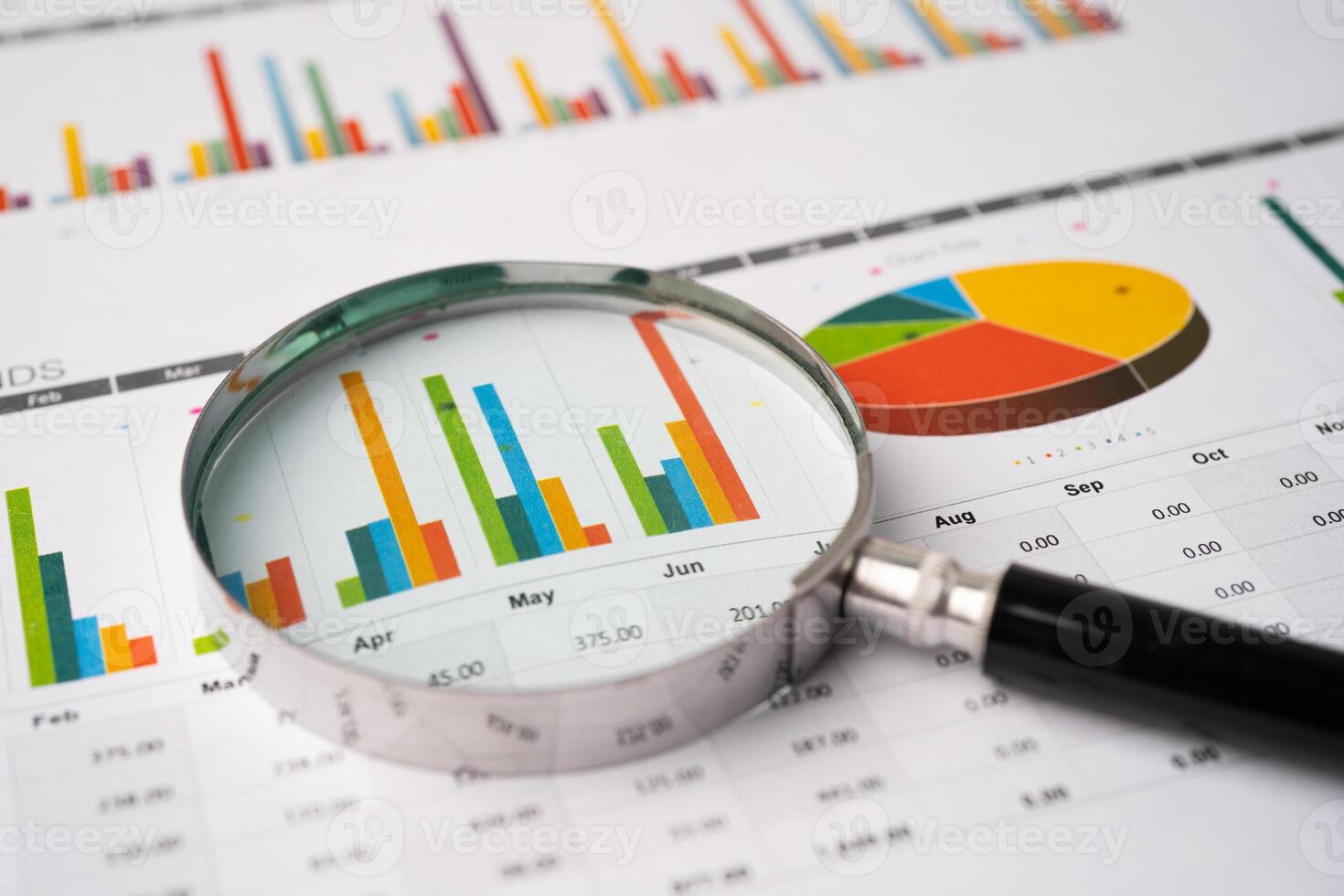 Magnifying glass on charts graphs paper. Financial development, Banking Account, Statistics, Investment Analytic research data economy, Stock exchange photo
