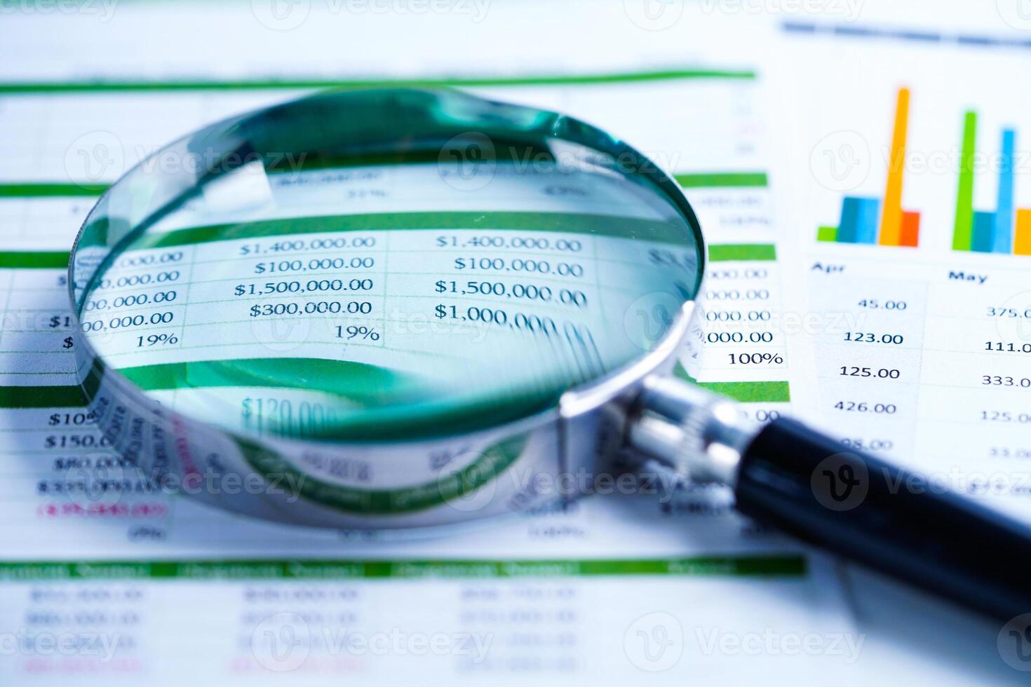 magnifying glass on graph photo