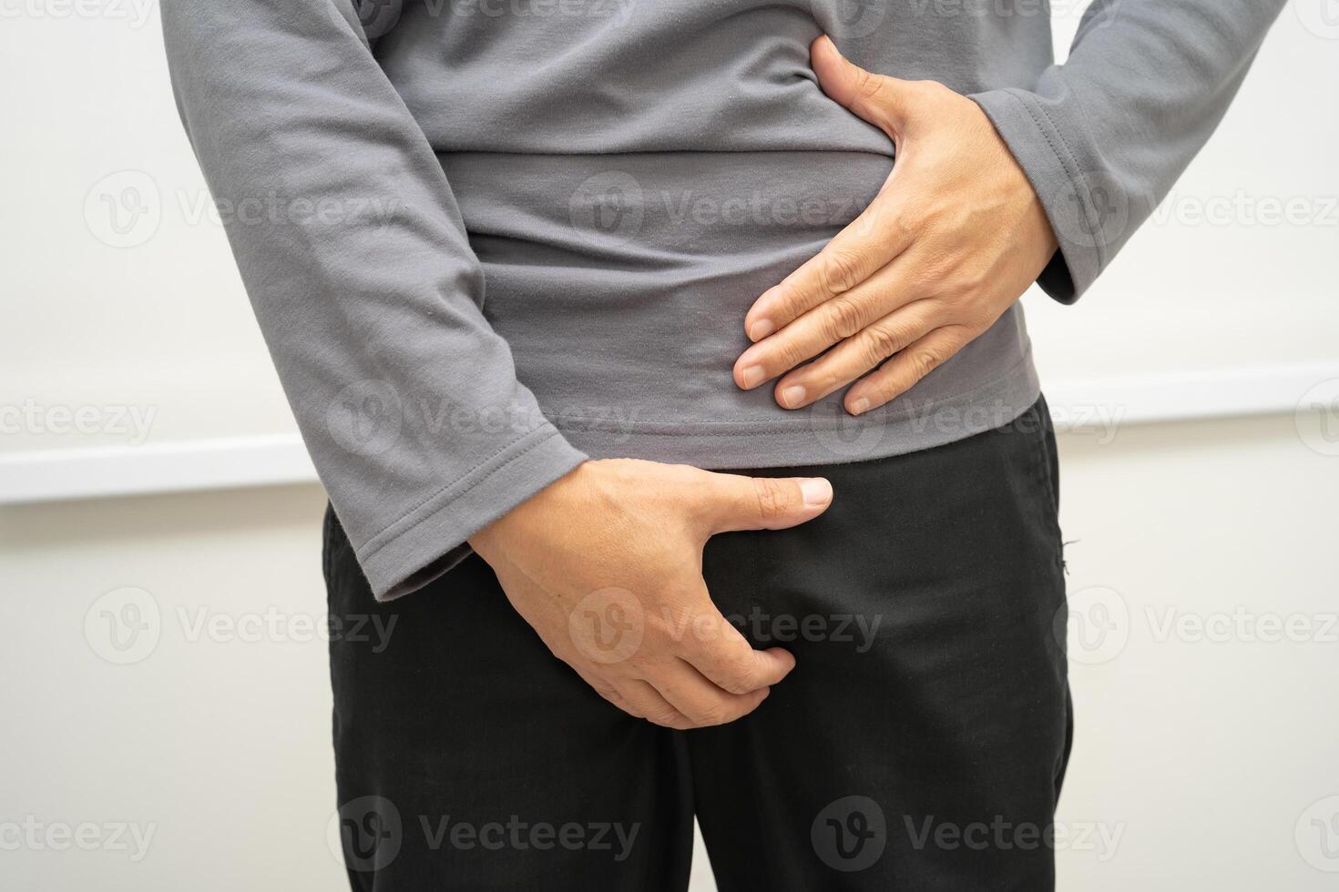 Hernia, Asian man stomach ache, abdominal pain and urology problem health. photo