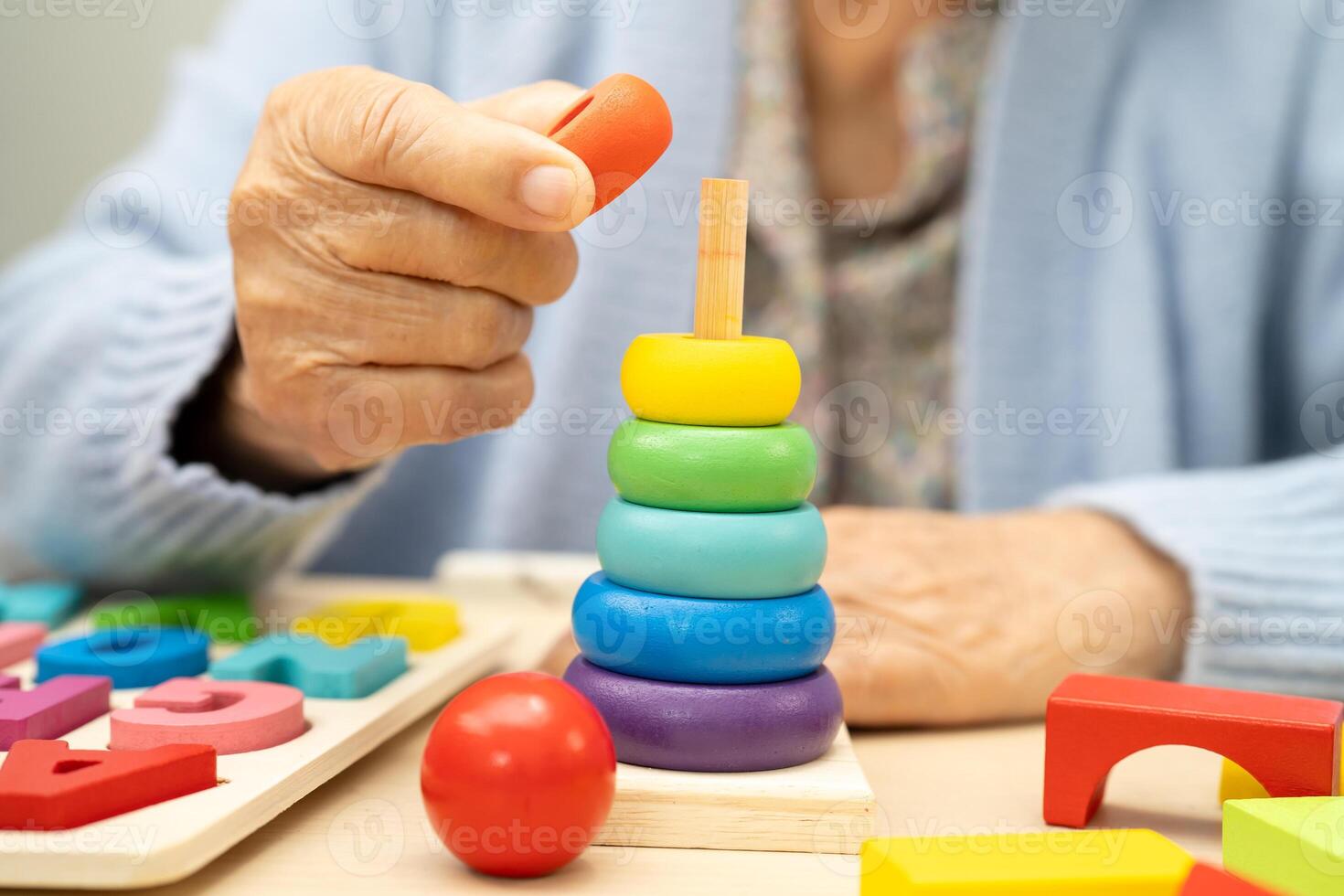 Alzheimer disease AD Asian elderly woman patient suffering from dementia learn practical motor skills rehabilitation. photo