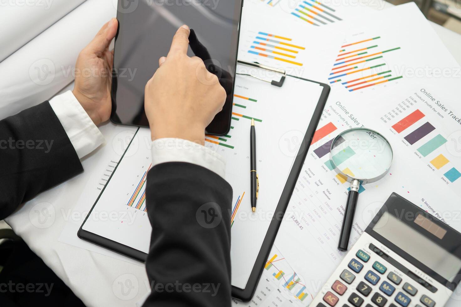 accountant working and analyzing financial reports project accounting with chart graph and calculator in modern office photo