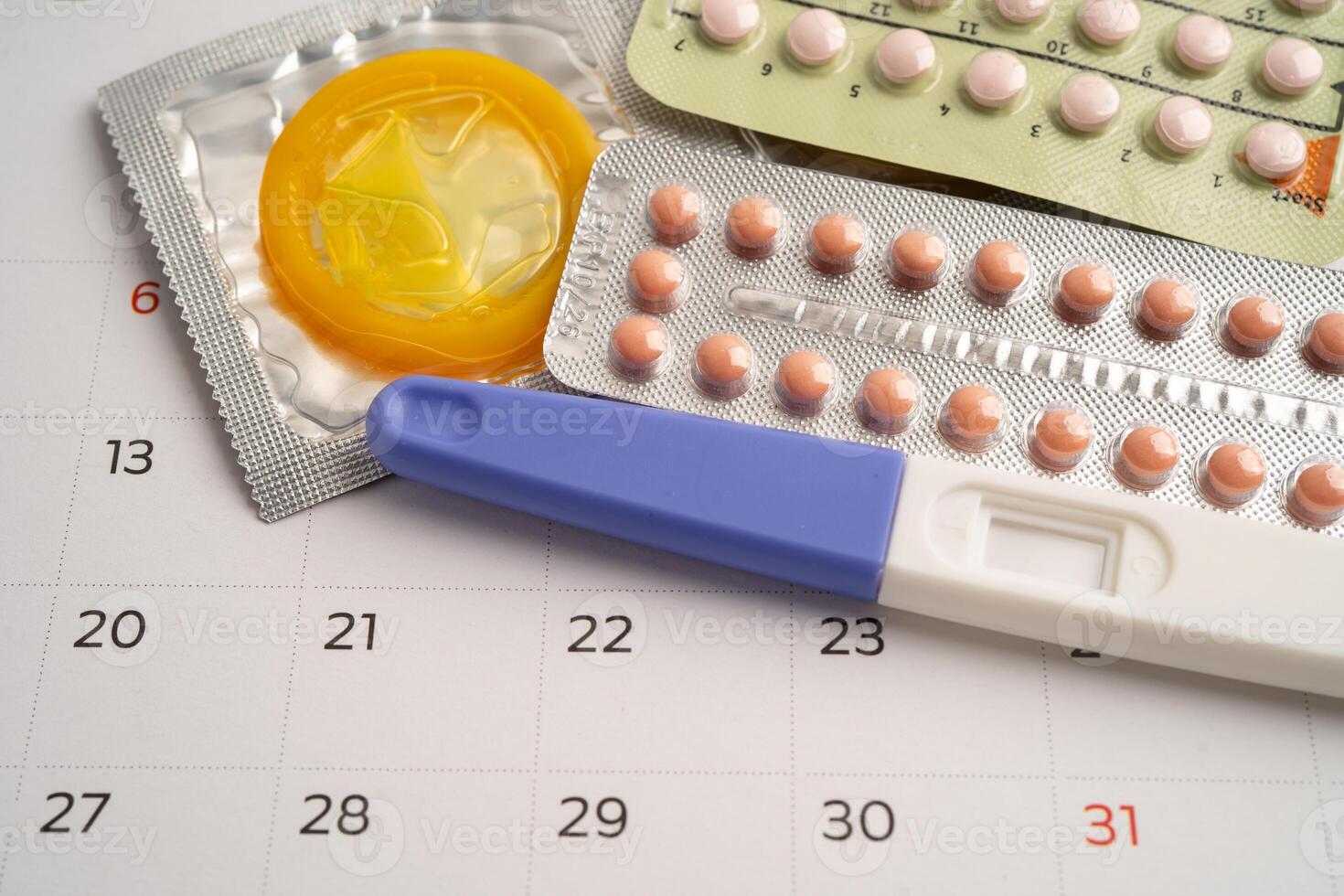 Pregnancy test and birth control pills calendar photo