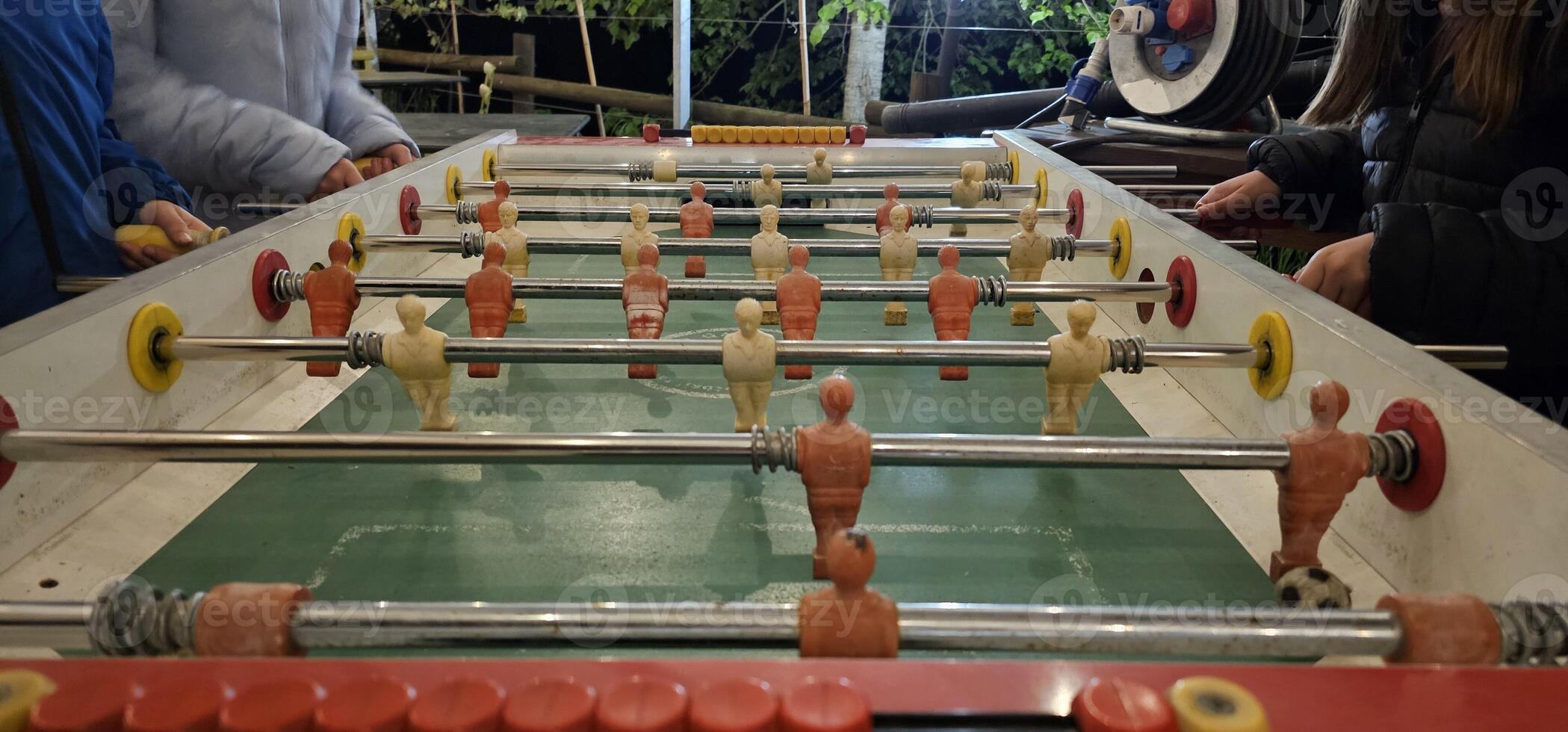 table football pitch, or foosball table, during a game between friends with the table football men chasing the ball photo