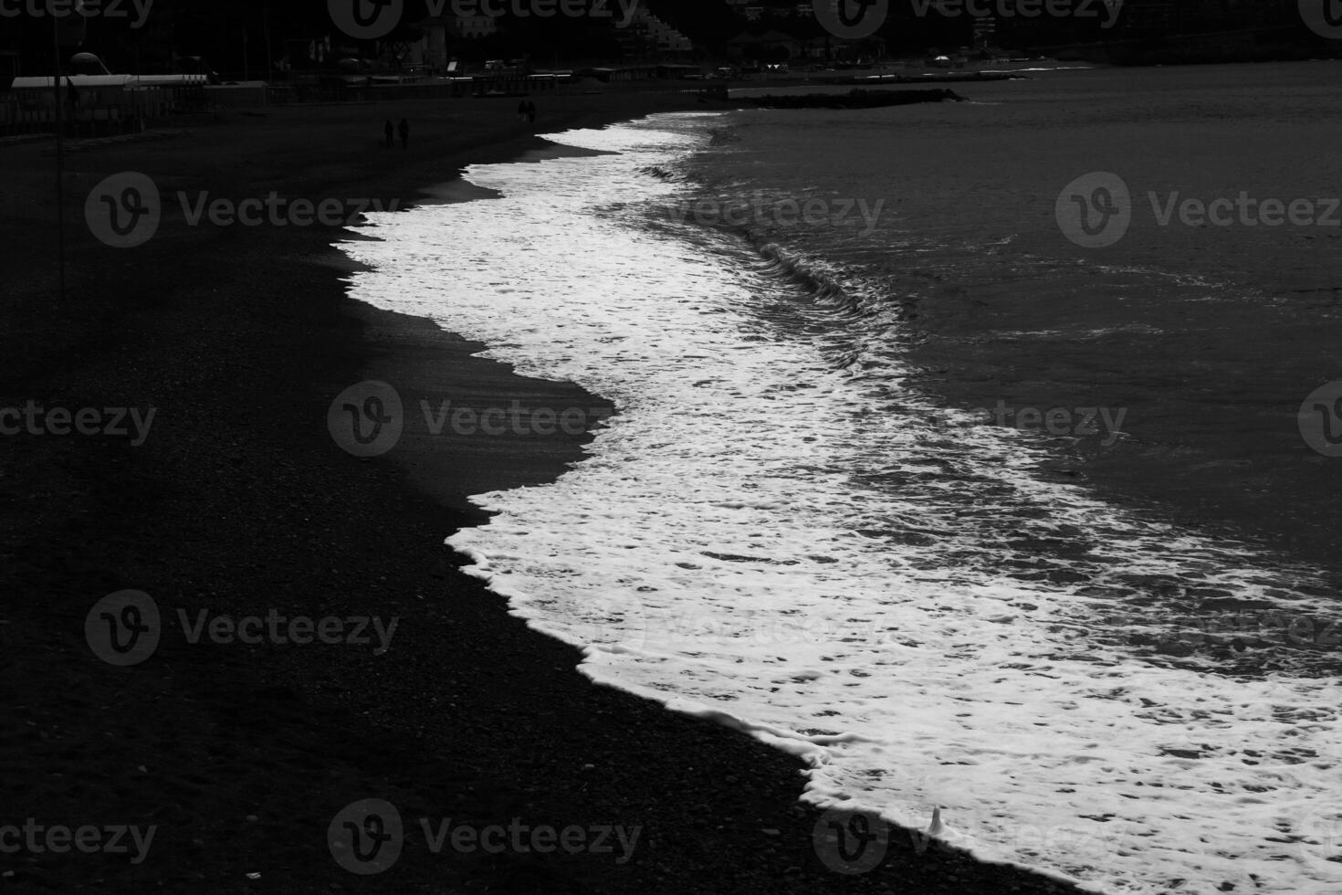the beach with dark colors, from the white of the sea to the beach photo