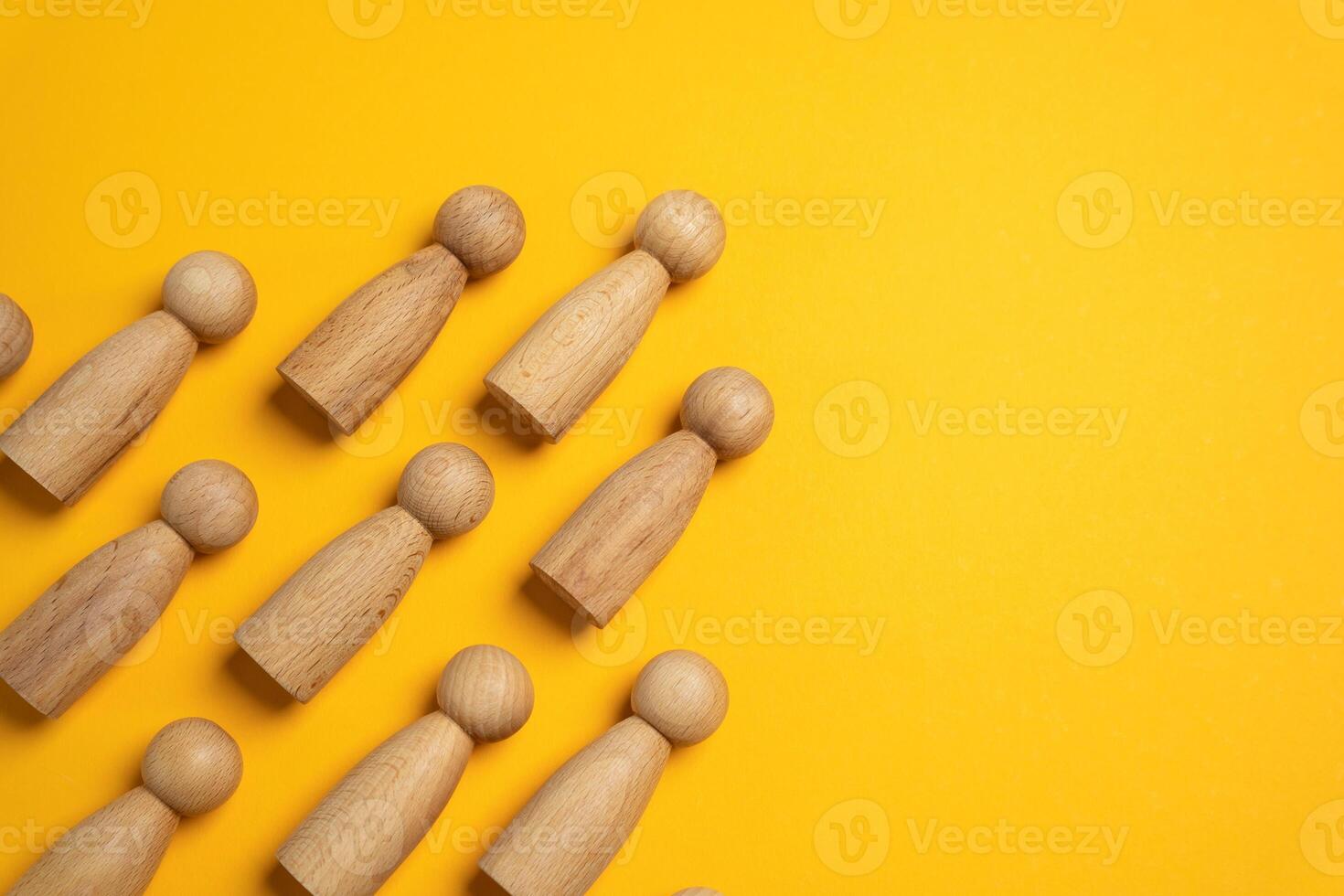 Figures of people in a pyramidal hierarchy. A group in the form of a wedge. Symbol of unity, discipline. Leadership, group organization, team structure, unity, or chain of command. photo
