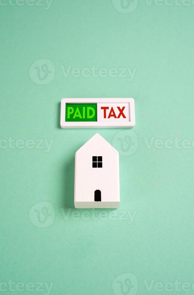 Tax paid for the house. The indicator lights up green, indicating successful payment of the property tax. Tax season. Financial responsibility. Avoid fines. Reduce expenses, get a refund. photo