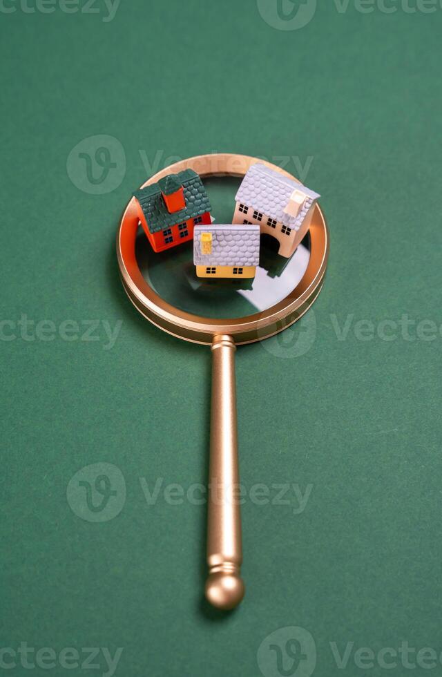 Houses on a magnifying glass. Buying a house. Monitoring and researching housing. Urbanism and urban development. Real estate market research. Investments in foreign real estate. History of buildings. photo