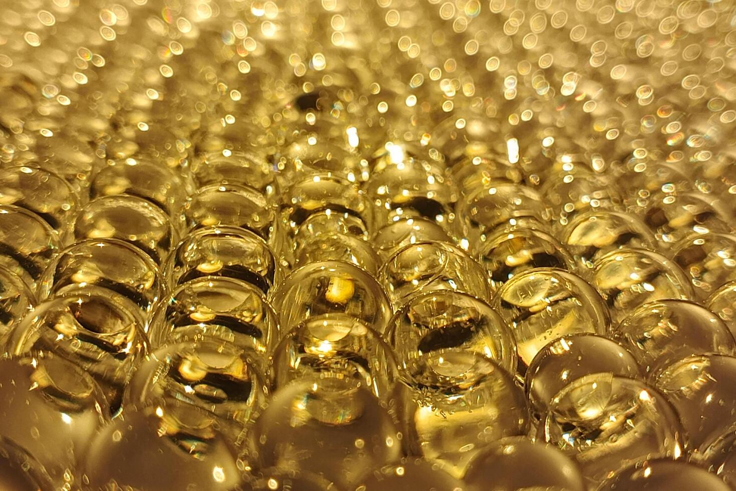 Golden bubbles in close-up, reflecting warm light with a dreamy, bokeh-filled background. photo