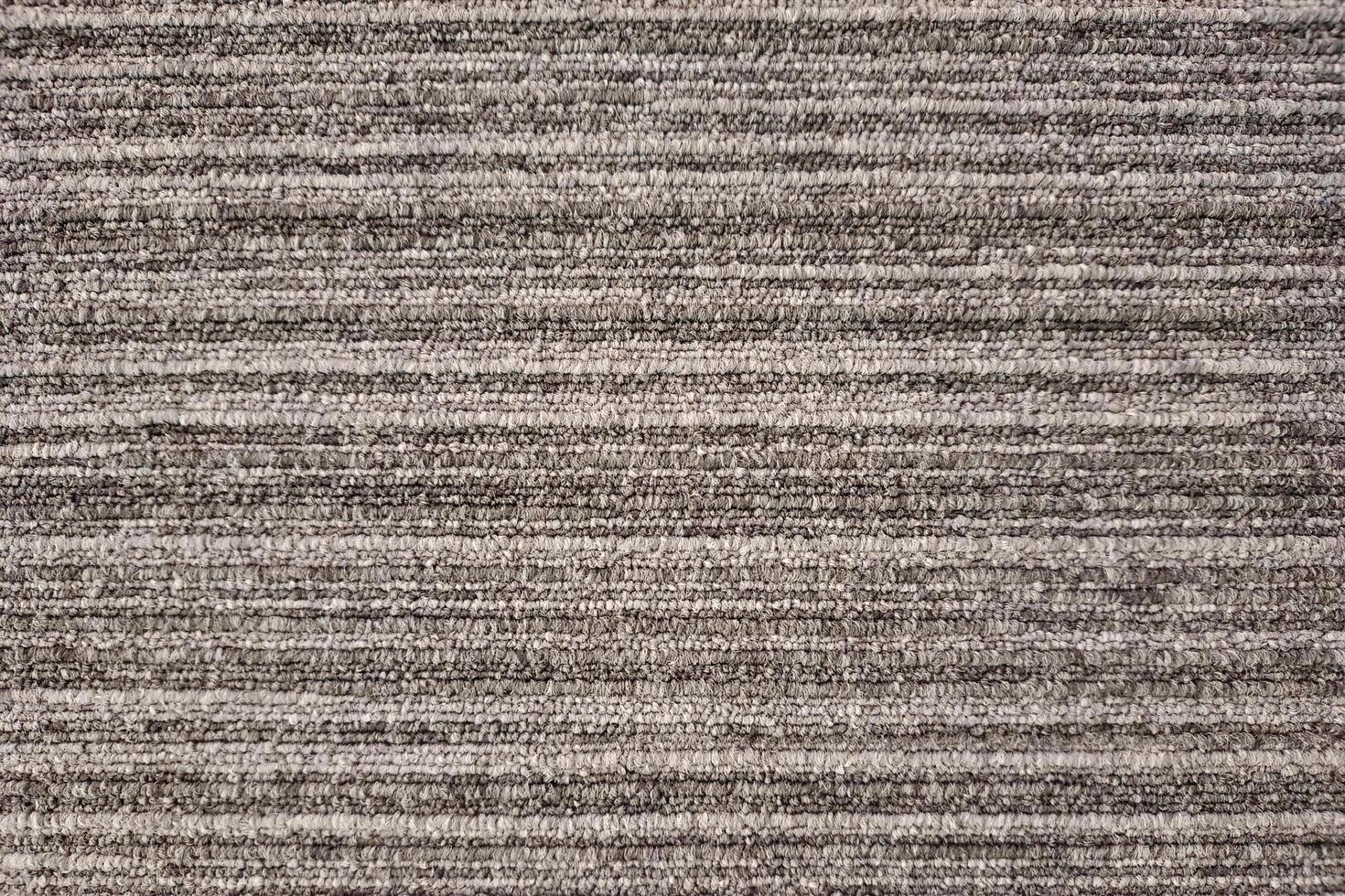 Close-up of a gray striped carpet with a textured, woven pattern.Close-up of a gray striped carpet with a textured, woven pattern. photo