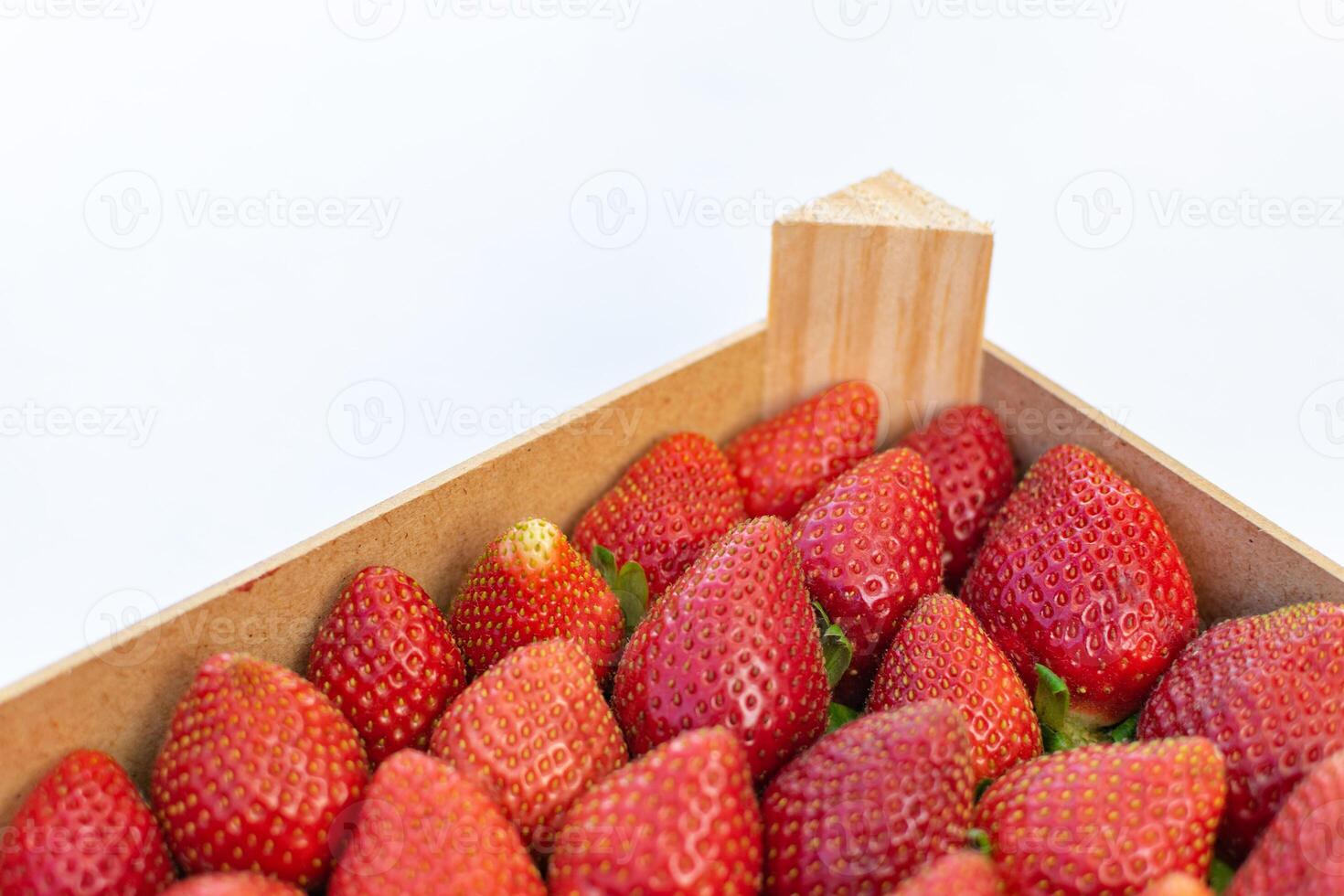 a macro image of a box of freshly picked strawberries in a box photo