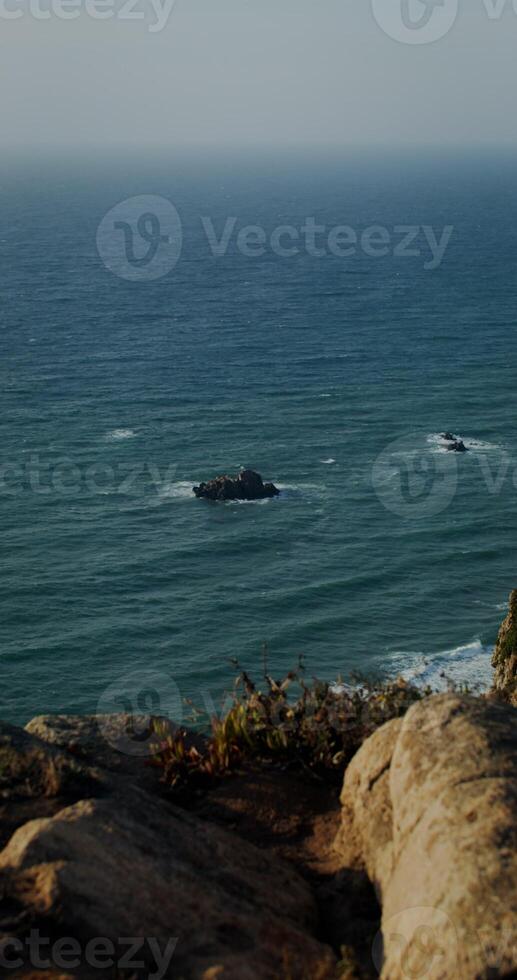 View from the top of the coastal cliff to the sea photo