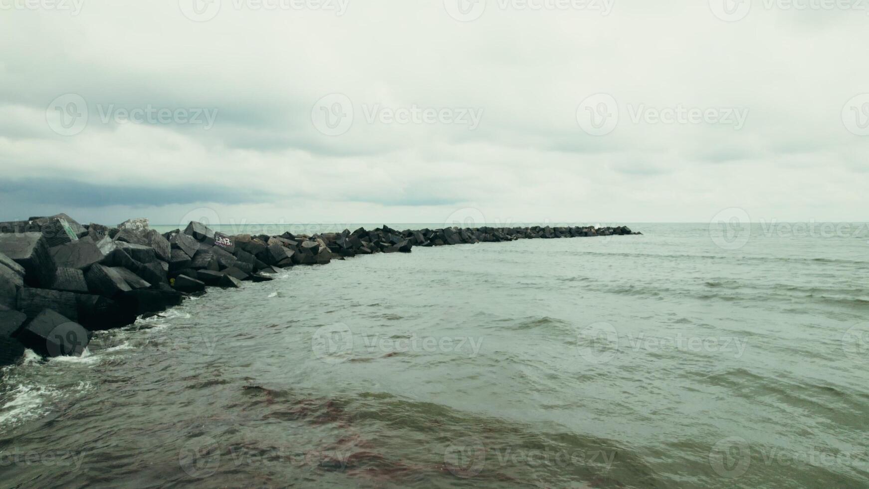 The drone flies over the sea from the shore into the distance photo