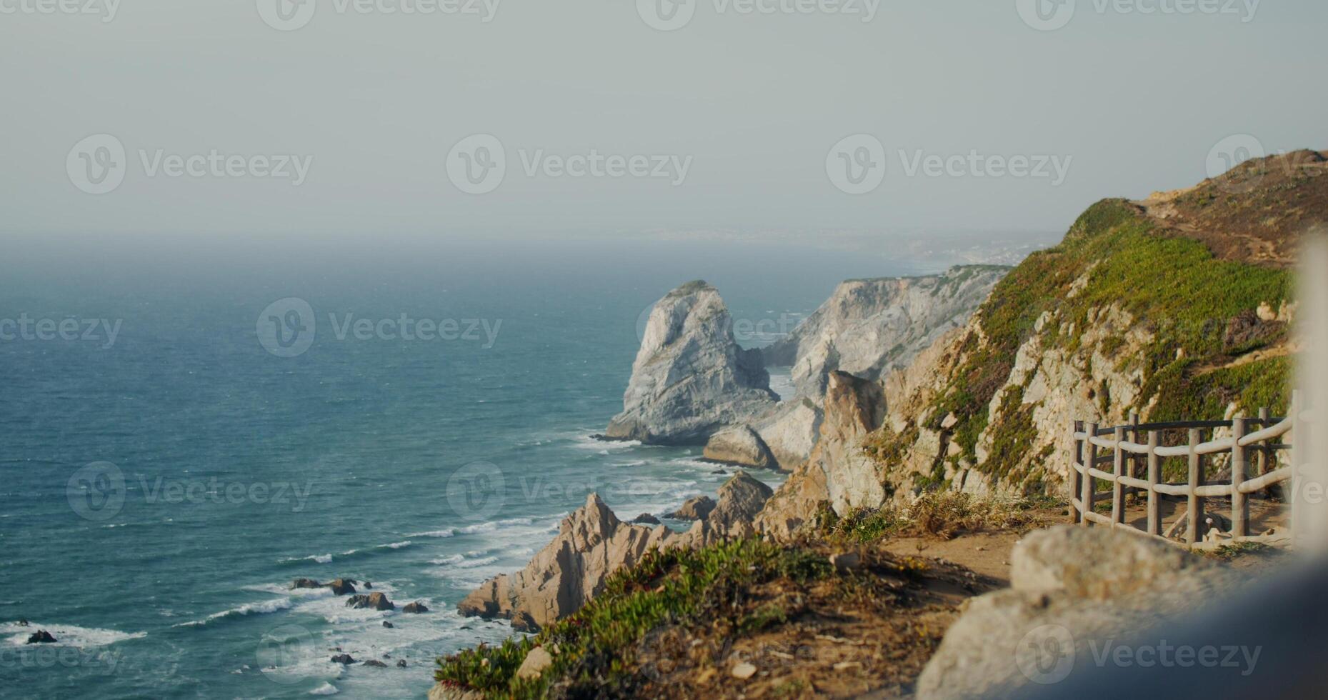 View of the sea washing the rocky shores and ledges. View from the top of the mountain photo