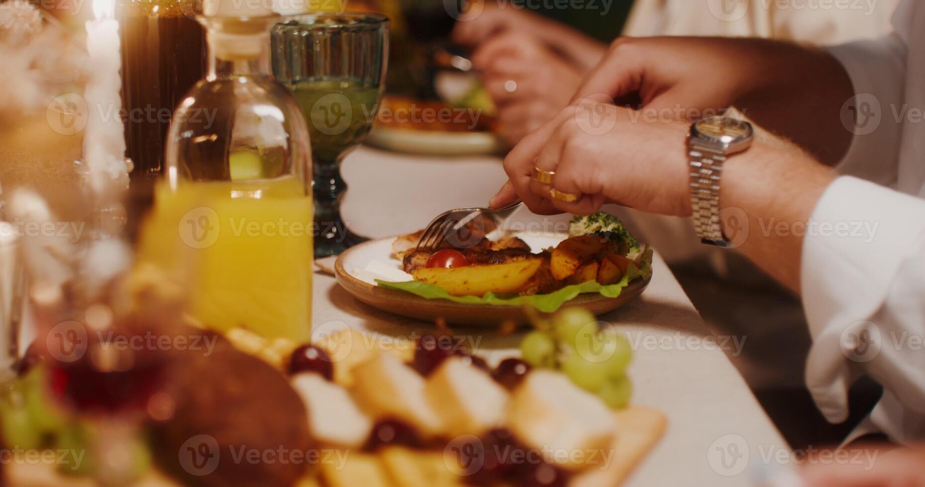 Men's hands use cutlery cutting steak. A man is sitting at a festive table, a close-up of his hands photo
