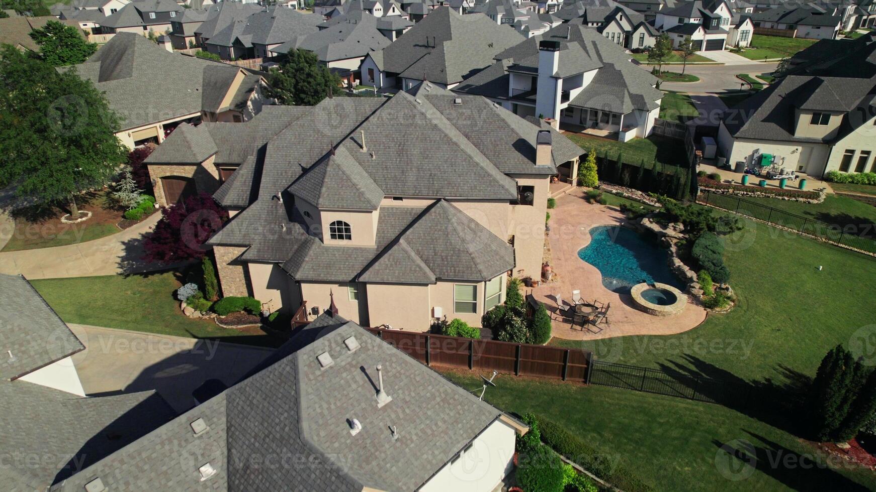 The drone is flying over the cottage area. The architecture of low-rise buildings in America. Summer day photo