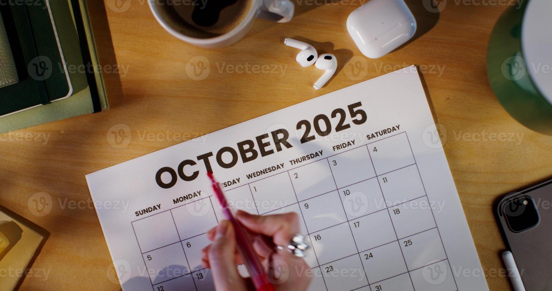The woman highlights the name of the month in the calendar with a red marker. photo