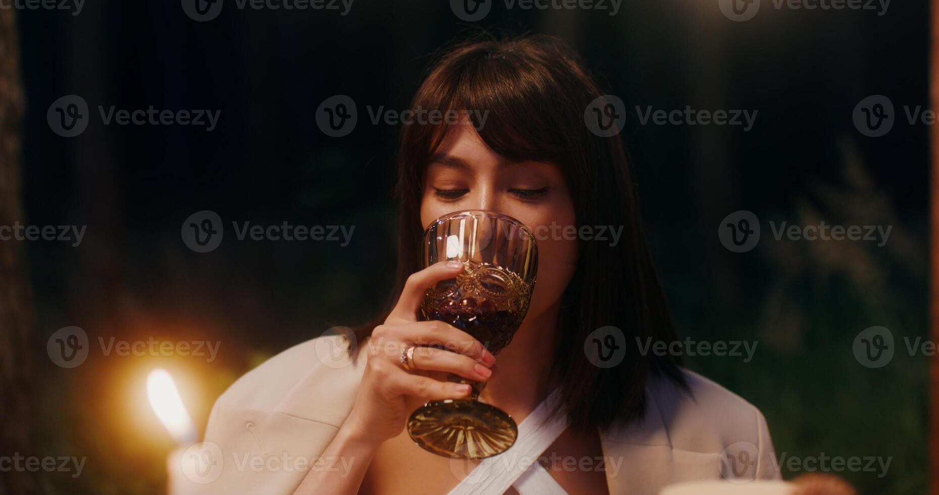A young beautiful woman drinks wine photo