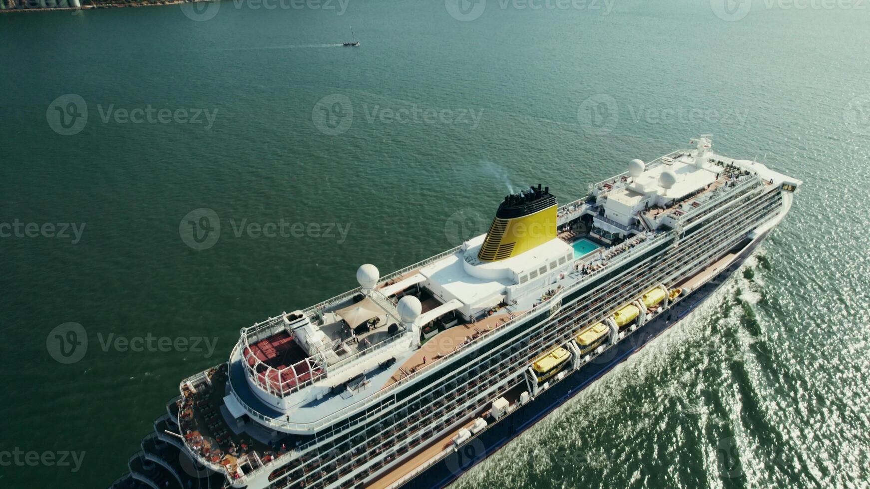 The drone flies over a multi-storey motor ship with a pool on the upper deck photo