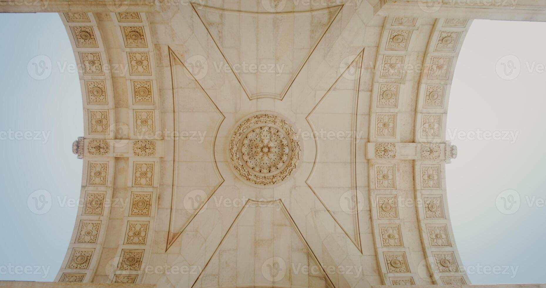 Ceiling of the marble triumphal arch in the classical style. Bottom-up view inside the arch photo