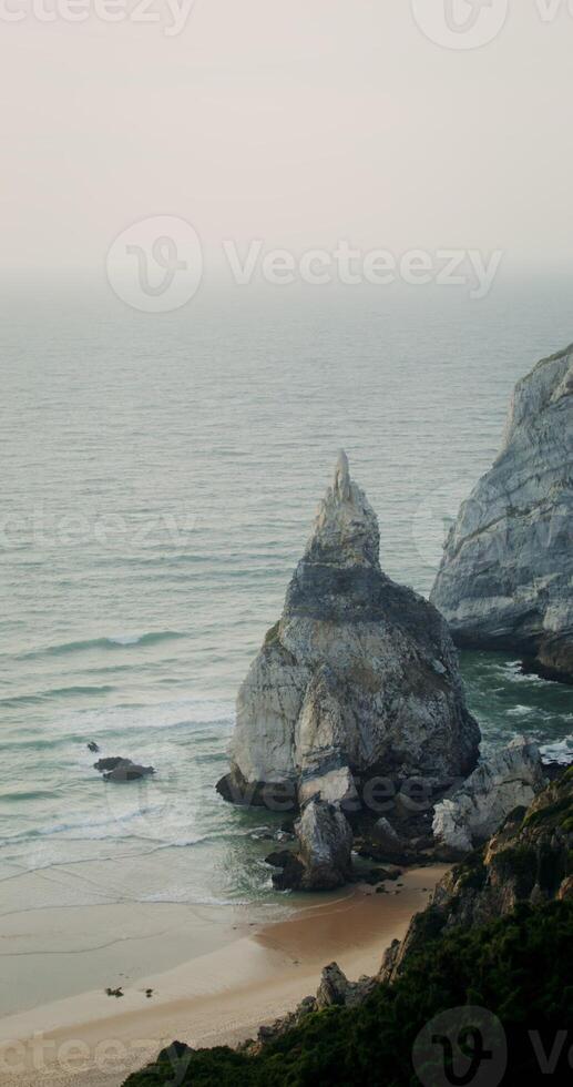 Top view of the coastline. Rocks sticking out of the water photo