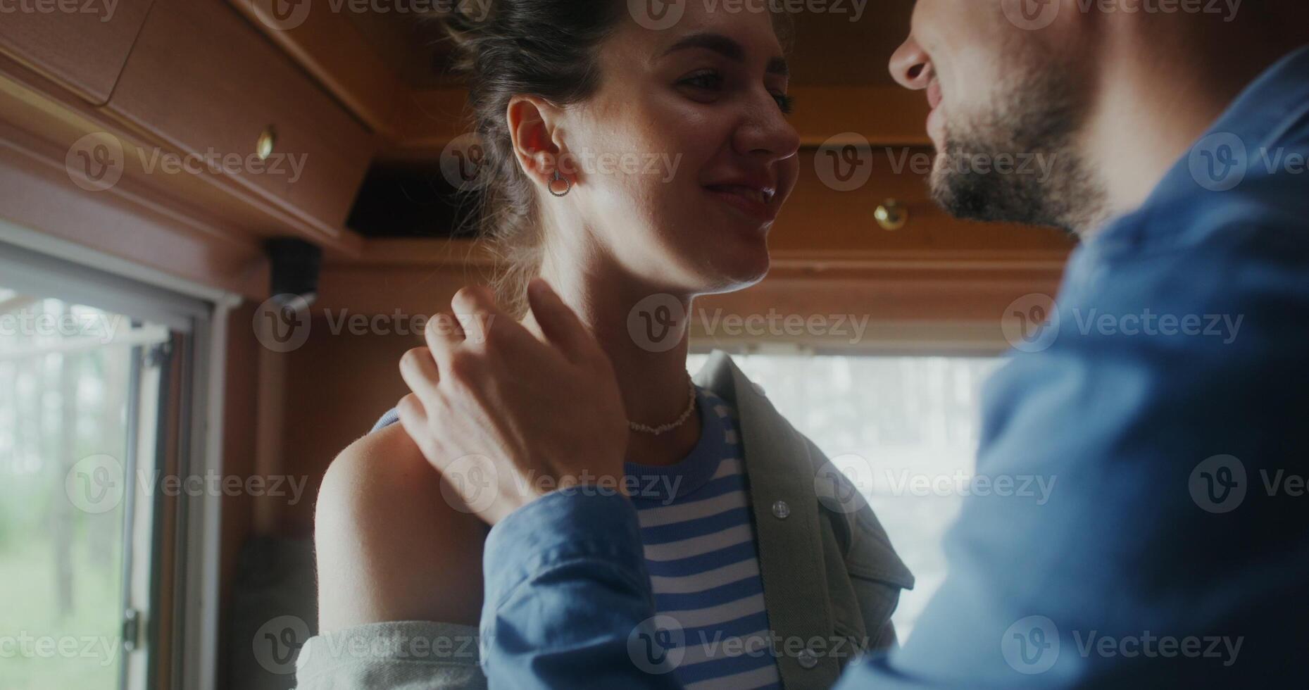 A man and woman are looking at each other in rv photo
