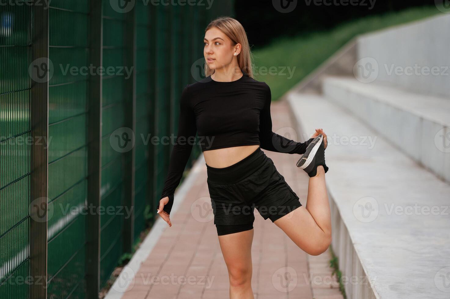 Warm up ,exercises. Beautiful ,fitness woman in sport clothes is outdoors photo