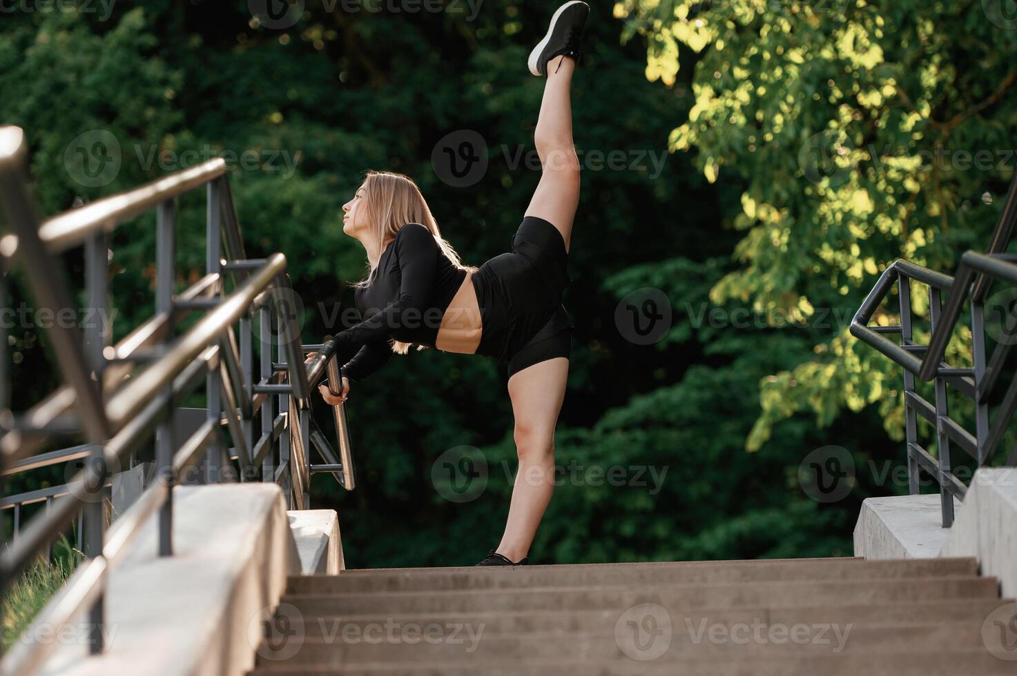 On the, bridge with stairs. Beautiful ,fitness woman in sport clothes is outdoors photo