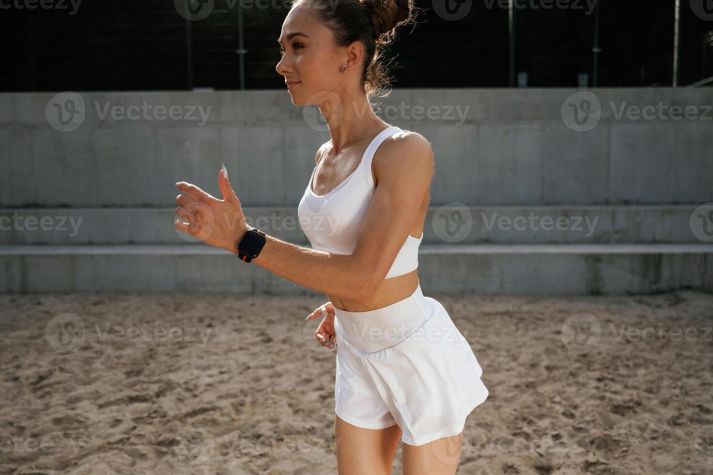 In white,, clothes. Young skinny fitness woman is outdoors photo