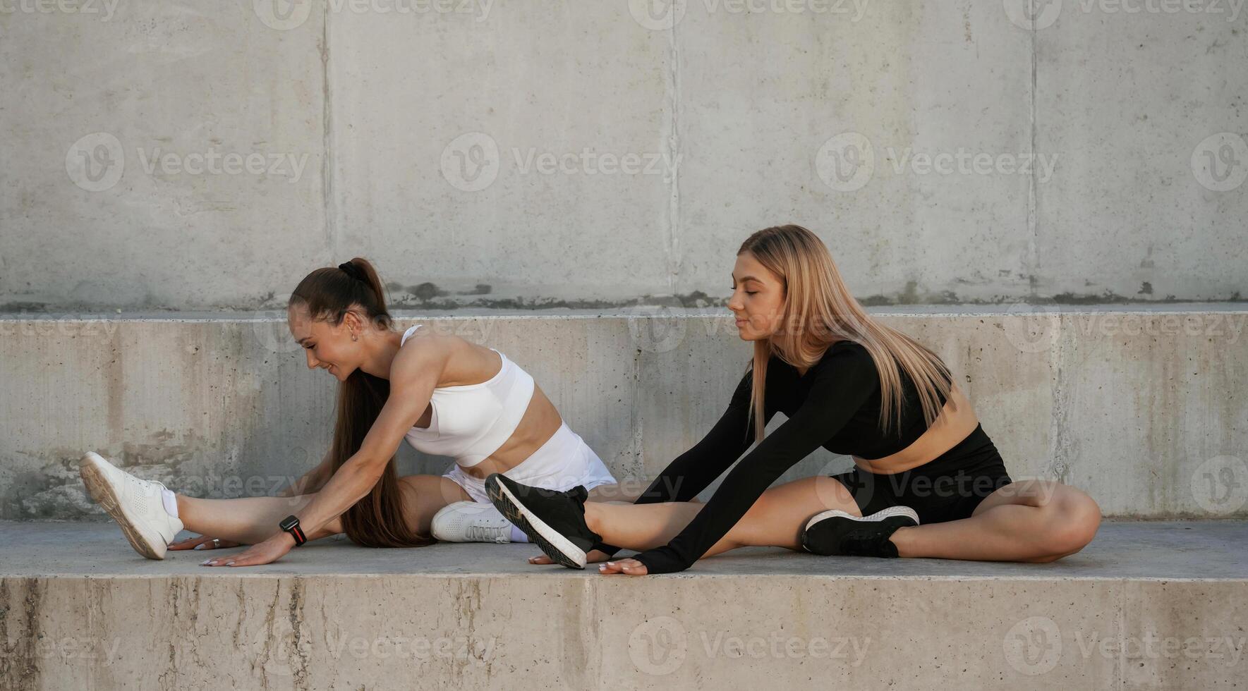 Two, sportive women are outdoors together photo