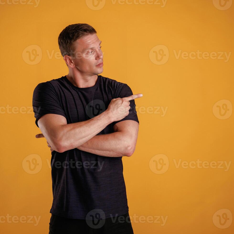 Invisible copy space, arms. ...Man is against background in the studio photo