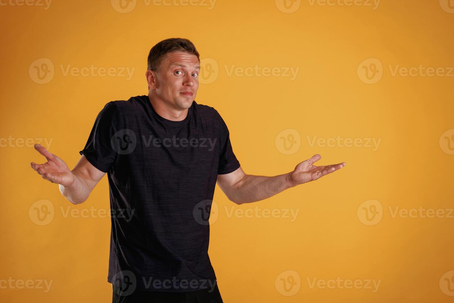 Confused, don't know what to do. ,,Man is against background in the studio photo