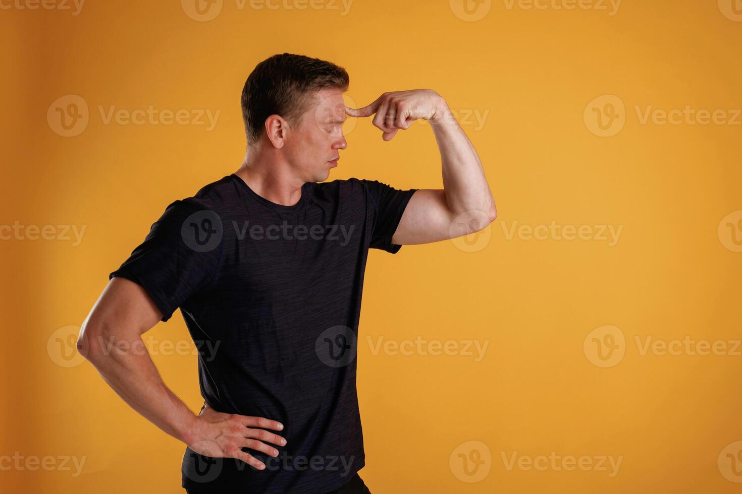 Thoughtful f,acial expression. Man,, is, against background in the studio photo