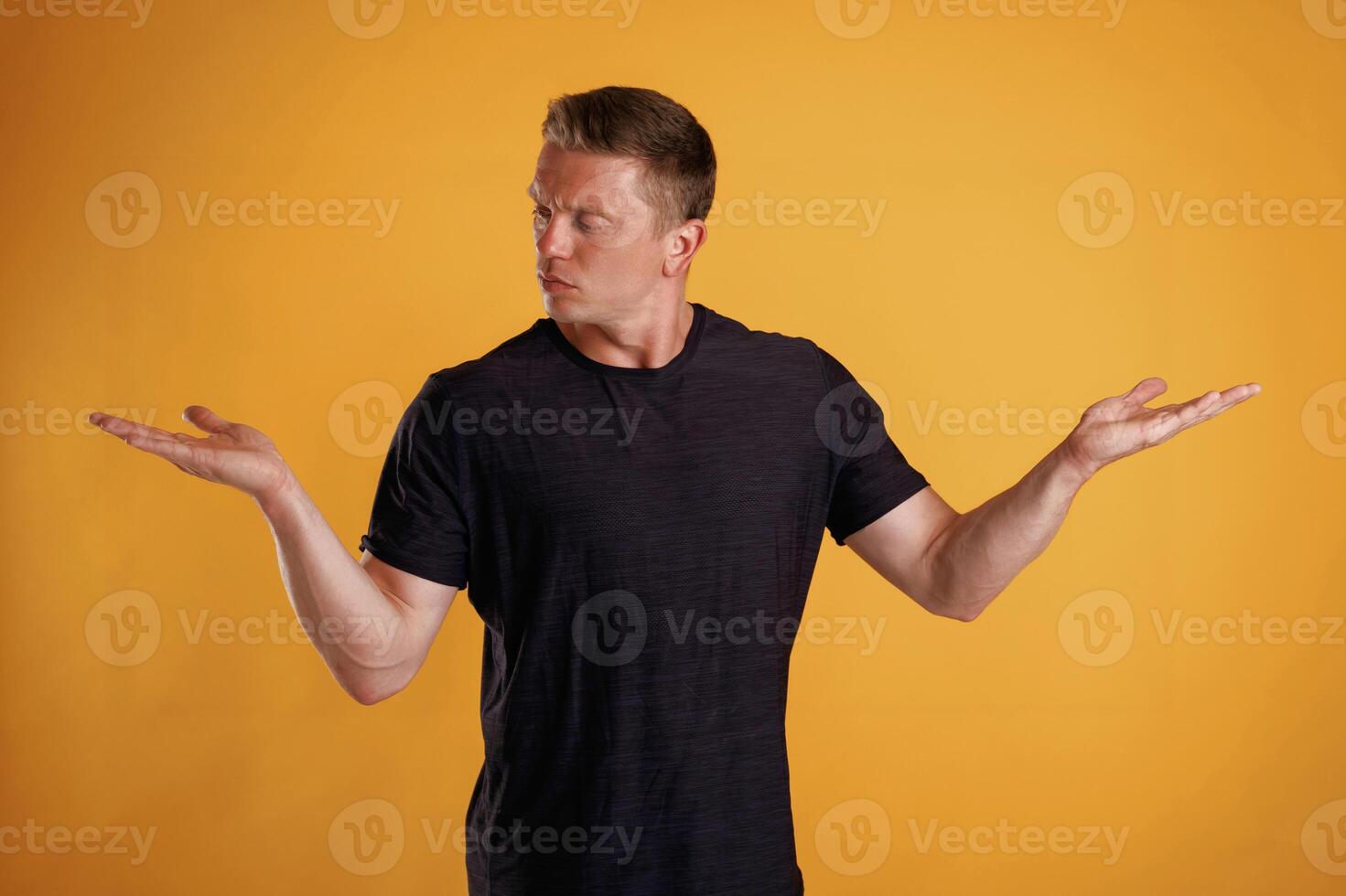 Choice of two different things, copy space. Man is against background in the studio photo