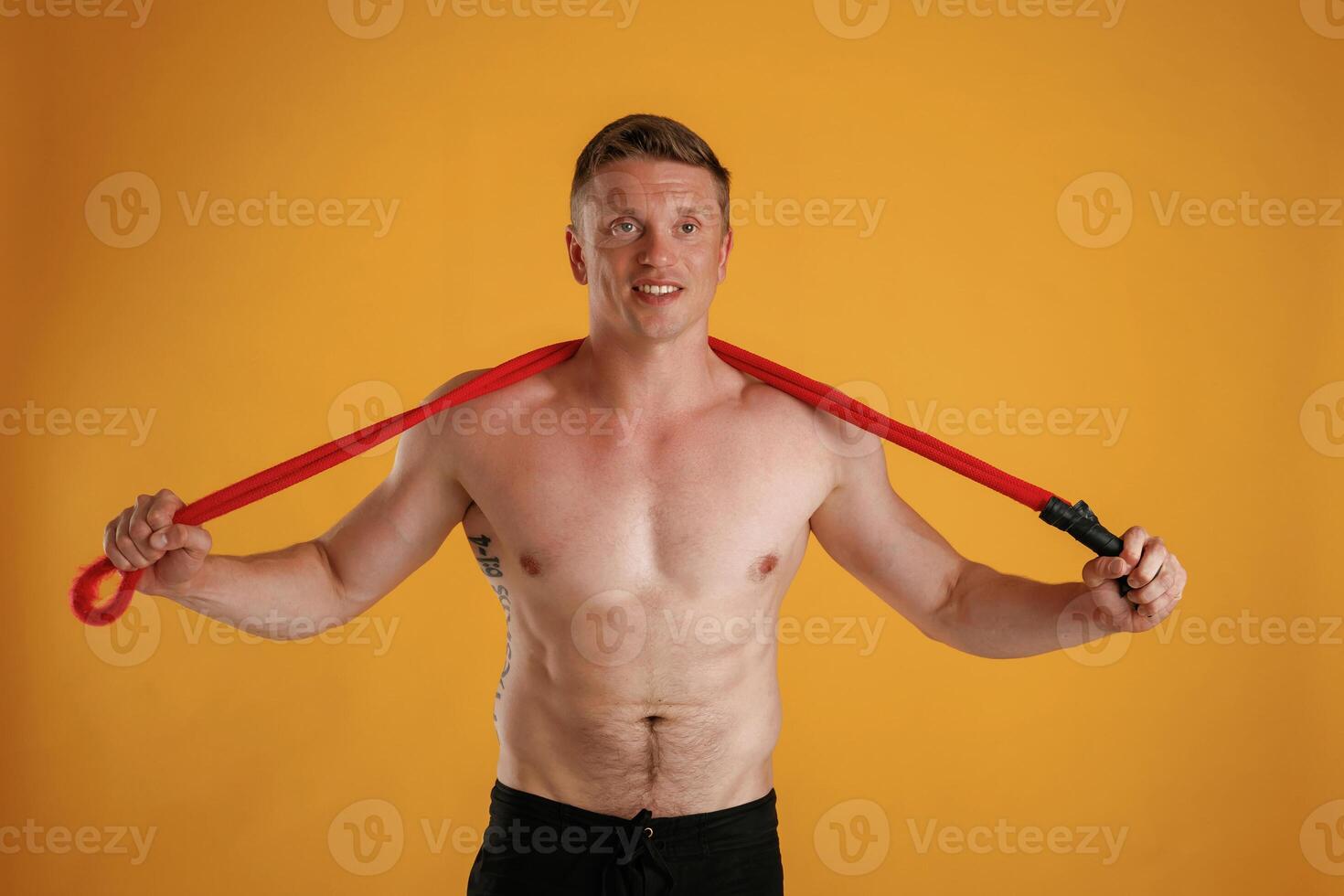 Red jump ropes, endurance ,,,and ,sport concept. Man is against background in the studio photo