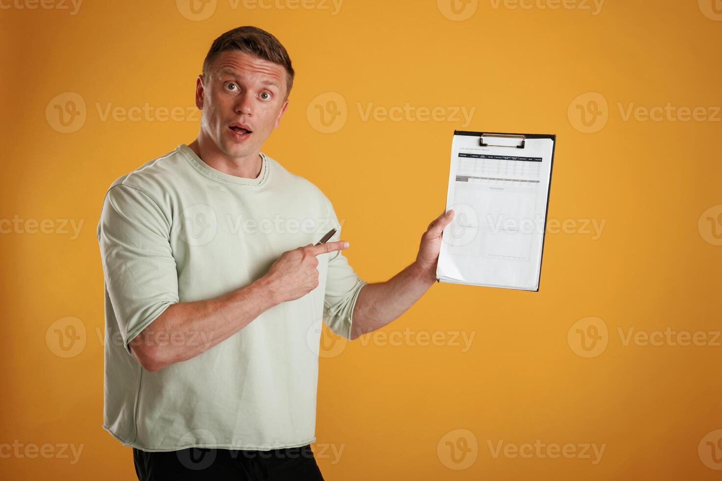 Results,, data in the notepad,,, holding it. Man is against background in the studio photo