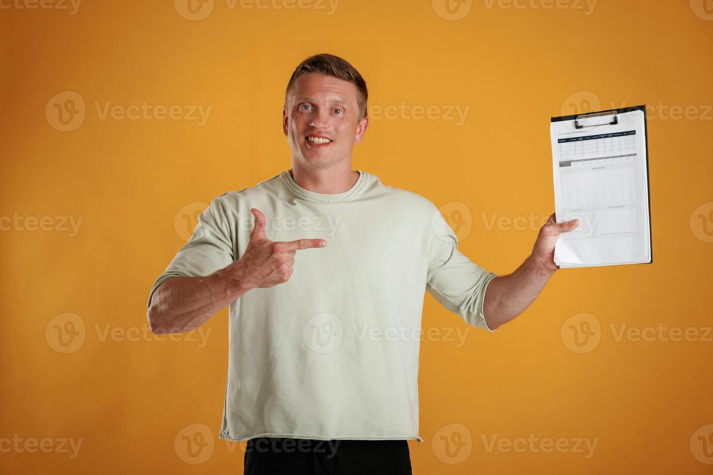 Results, data in the notepad,,, holding it. Man is against background in the studio photo