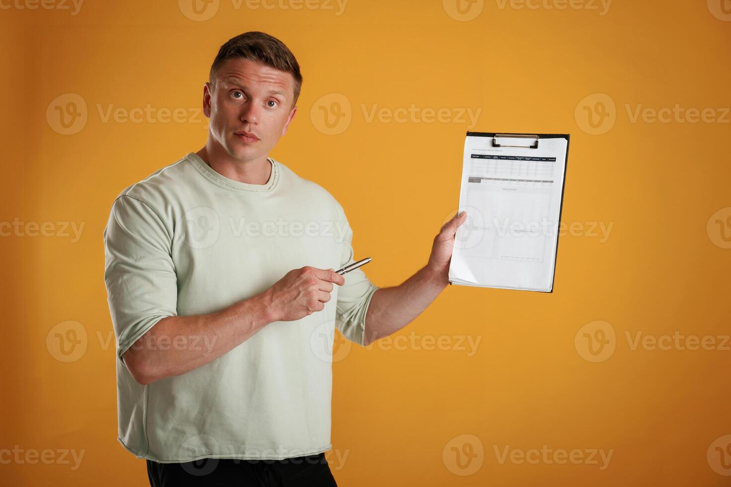 Results, data in, the ,notepad, holding it. Man is against background in the studio photo