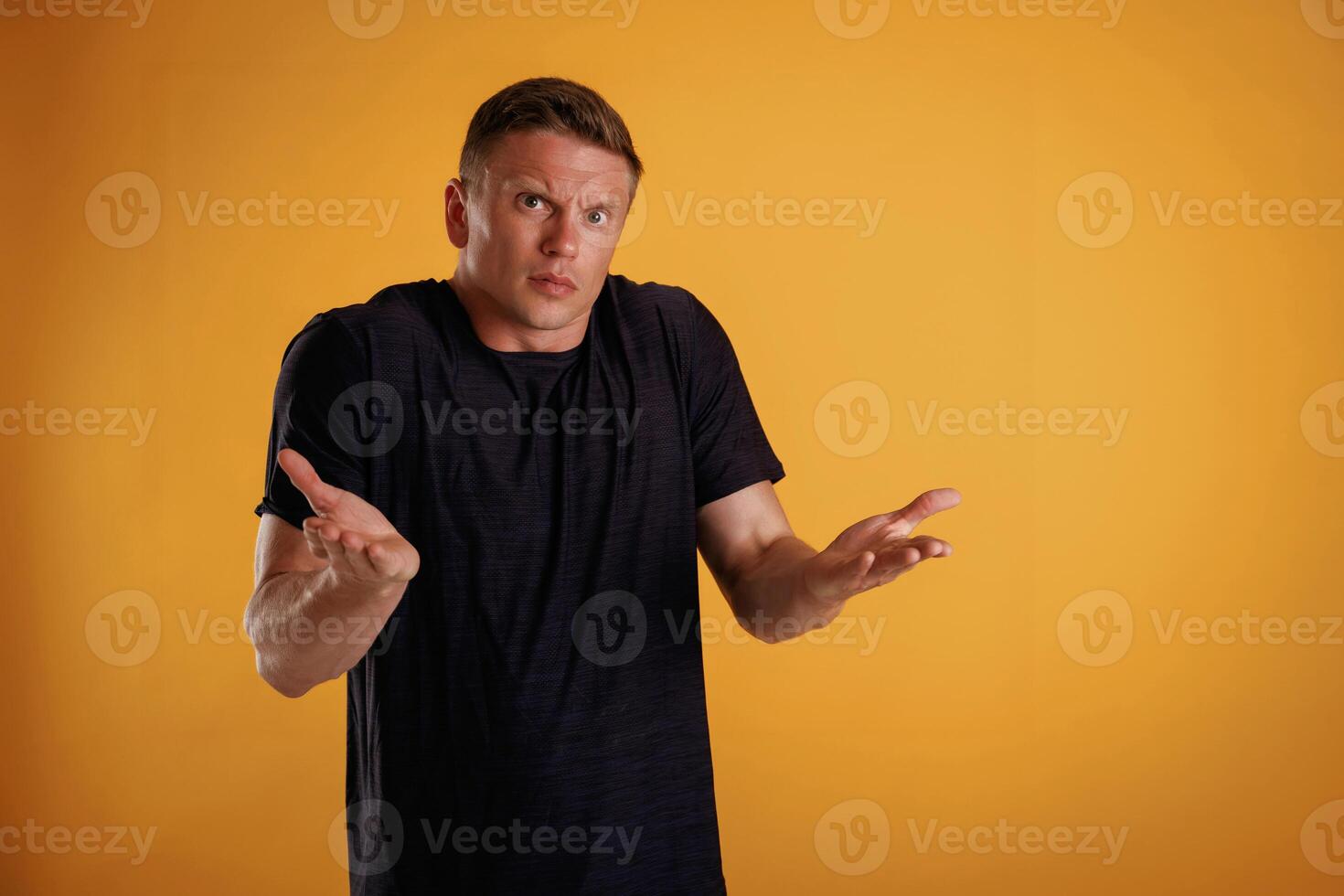 Confused, don't ,know what to do. Man is against background in the studio photo