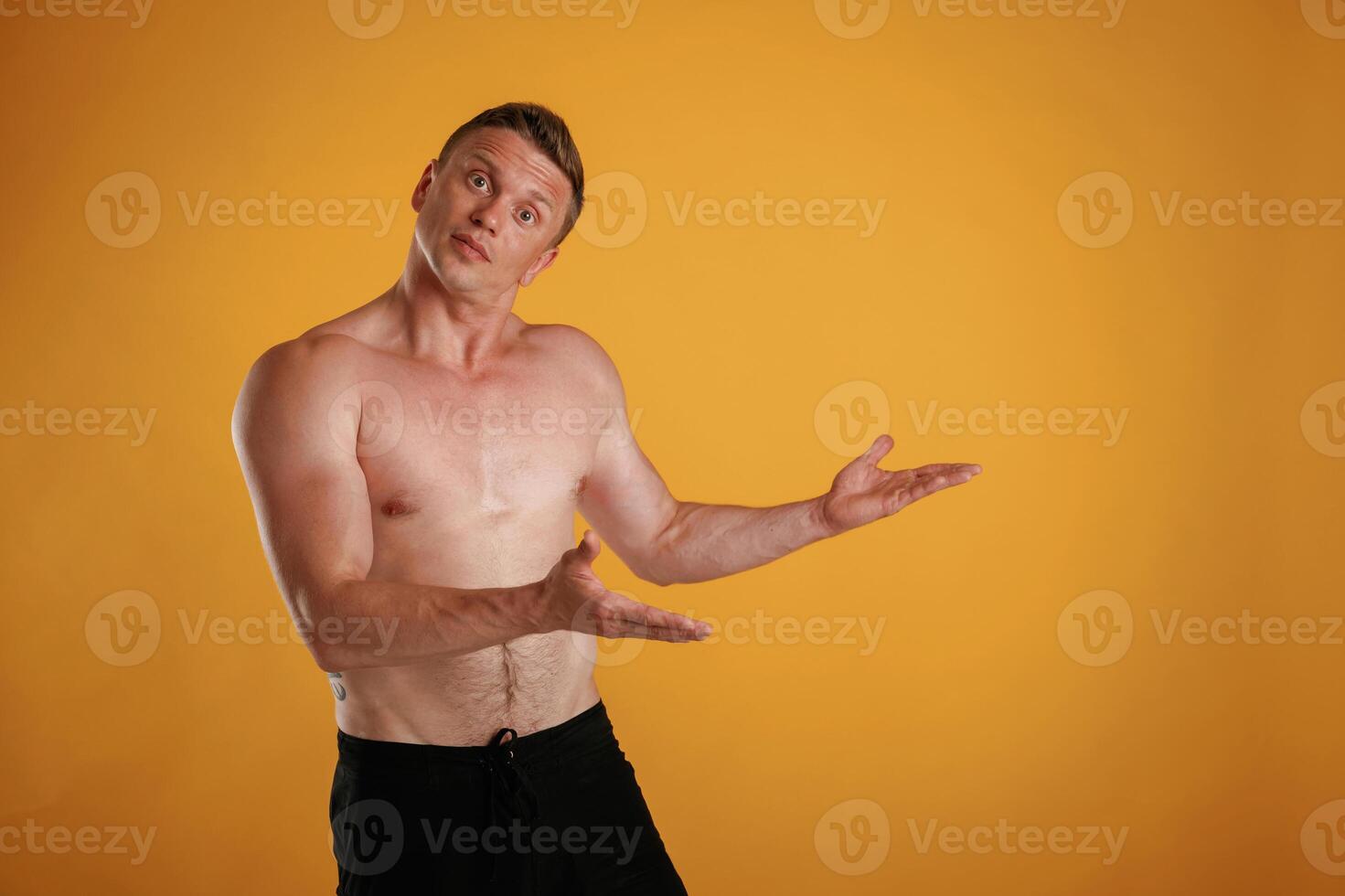 Take, a look to the side, copy space, shirtless. Man is against background in the studio photo