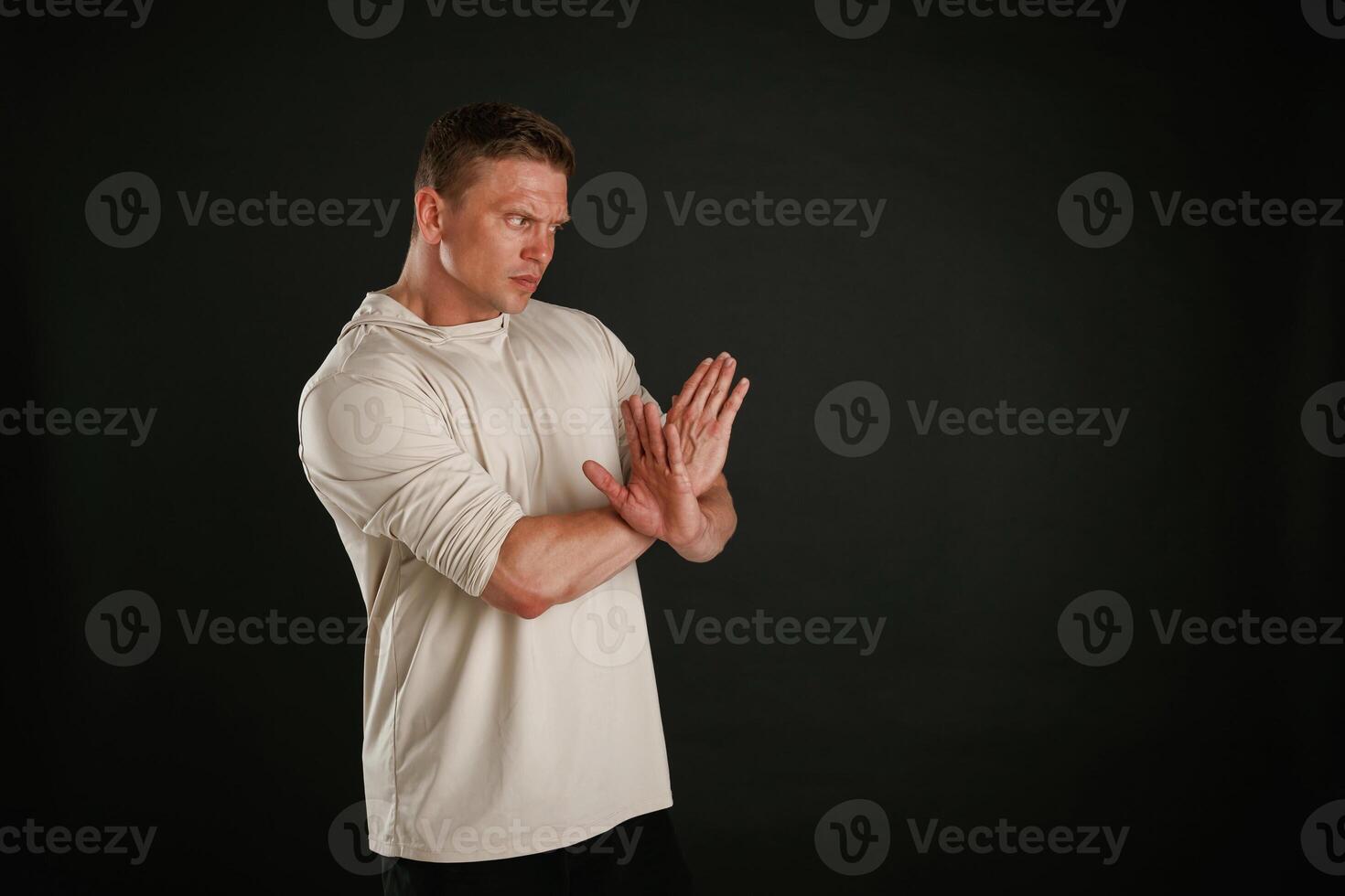 I refuse, stop gesture by hands. Man is against background in the studio photo