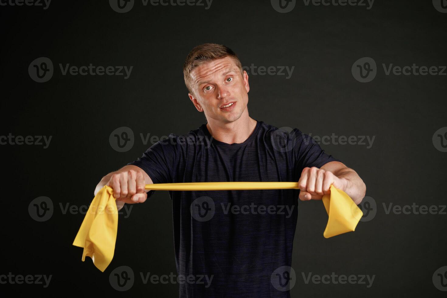 Yellow fitness,, rope. Man is against,,, background in the studio photo