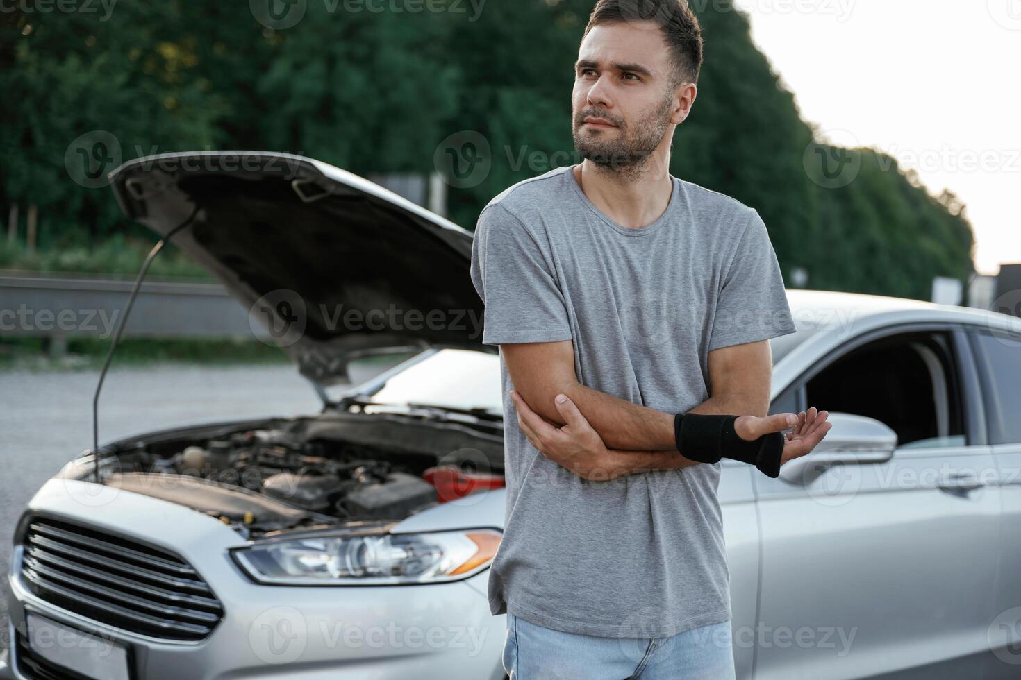 Pain is in the hand, accident, broken automobile. Man is with his car outdoors photo